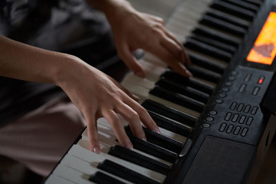 Midsection of man playing piano