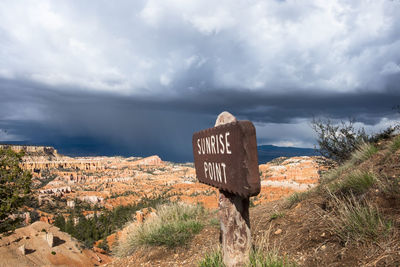 Information sign against sky