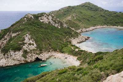 High angle view of sea and mountains against sky