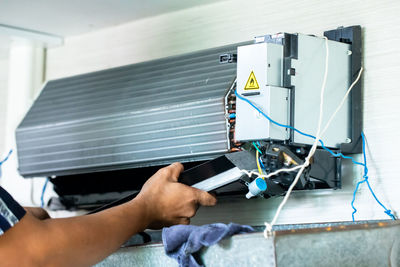 Cropped hand of man repairing car