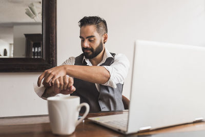 Handsome man dressed as executive working on the laptop