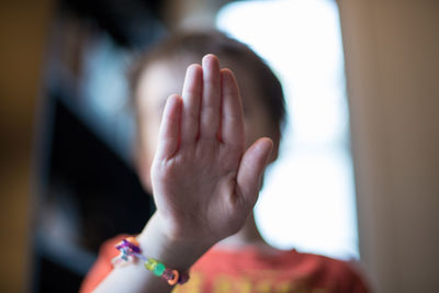 Girl showing hand at home