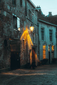 Street amidst buildings in city at night