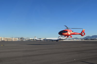 Close-up of red wall against clear blue sky