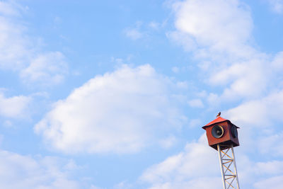 Low angle view of road sign against sky