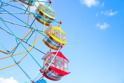 Low angle view of ferris wheel against sky