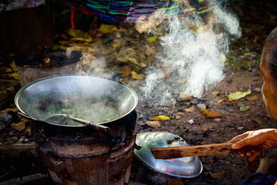 High angle view of person preparing food on barbecue grill