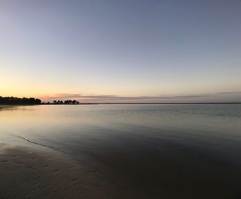 Scenic view of sea against clear sky at sunset
