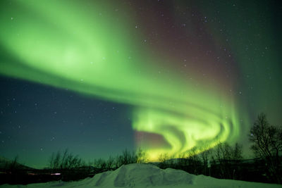 Scenic view of landscape, aurora borealis  at night sky