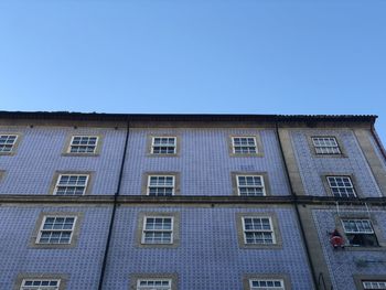 Low angle view of building against clear blue sky