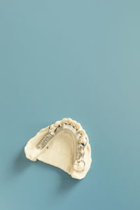 Close-up of dentures against blue background