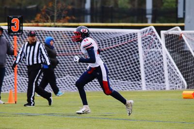 Teenage boy playing american football 