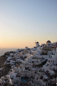 High angle view of townscape by sea against clear sky