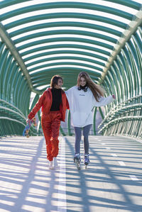 Full length of woman walking on footbridge