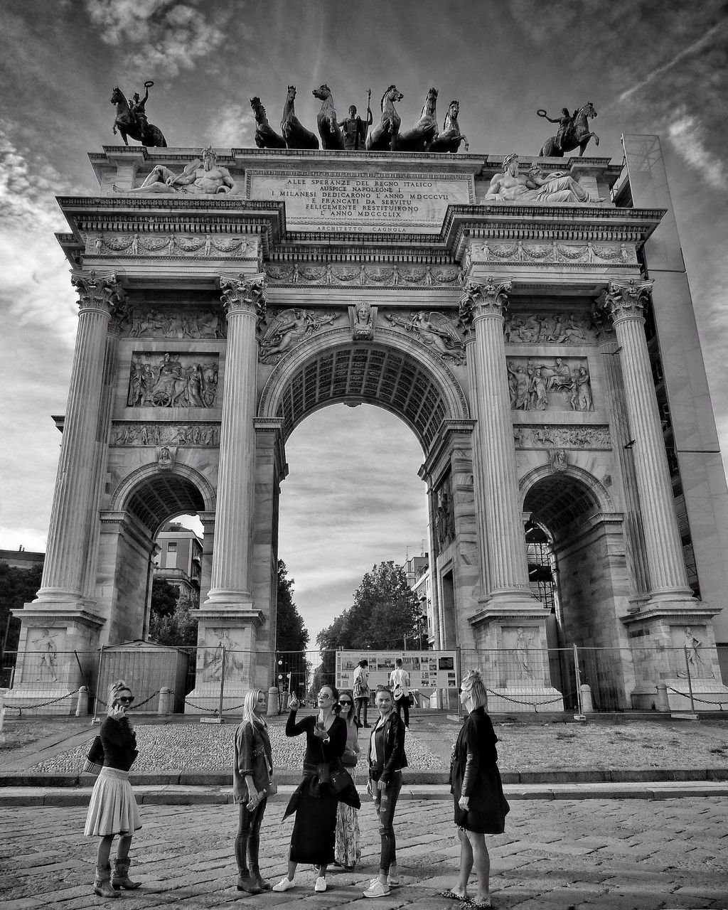 PEOPLE WALKING IN FRONT OF HISTORICAL BUILDING