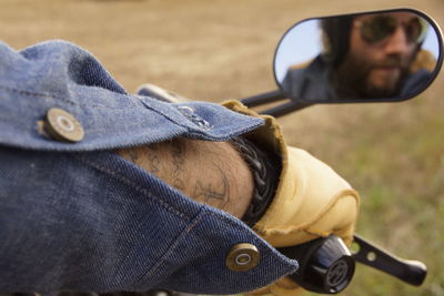 Cropped hand of man riding motorcycle