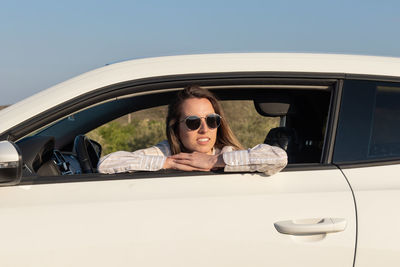 Portrait of young woman in car