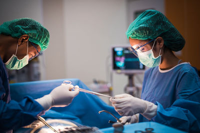 Surgeons operating patient in hospital