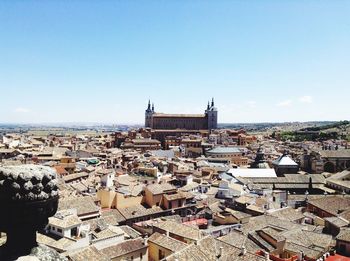 High angle view of city against blue sky