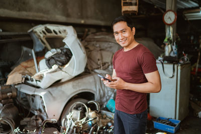 Side view of young man using mobile phone