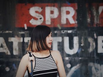 Woman standing against wall