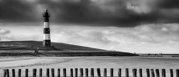 Lighthouse against cloudy sky