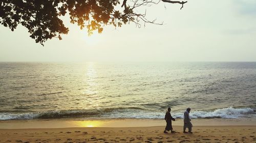 Scenic view of people on beach