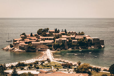 High angle view of buildings by sea