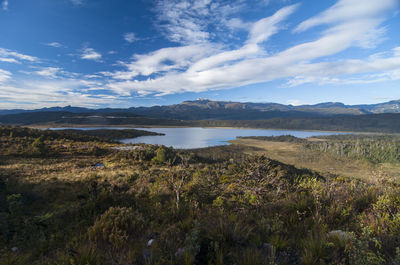 Scenic view of lake and mountains against sky