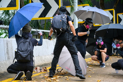 People walking on wet street in city