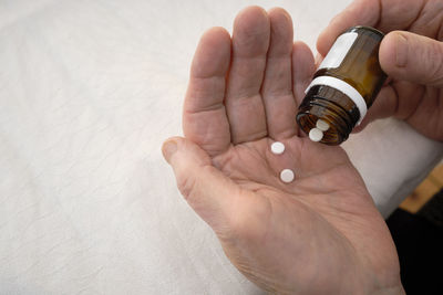 Close-up of person taking pills