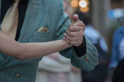 Close-up of man holding woman in city