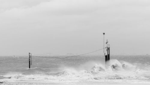 Scenic view of sea waves splashing against sky