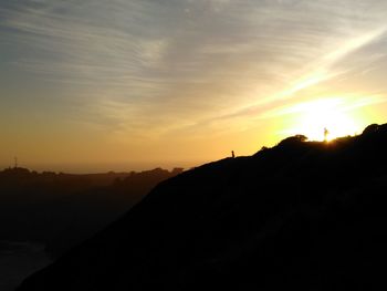 Scenic view of silhouette mountains against sky during sunset