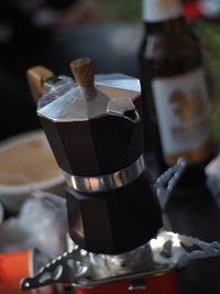 Close-up of hand holding coffee maker