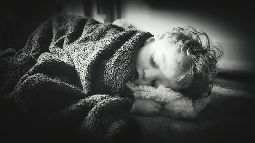 Close-up of girl sleeping on bed at home