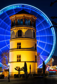 Illuminated ferris wheel at night