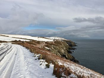 Scenic view of sea against sky during winter