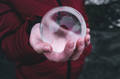 Close-up of hand holding ball glass