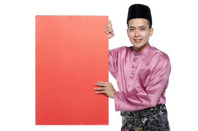 Portrait of a smiling young man against white background