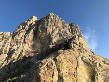 Low angle view of rocky mountain against sky