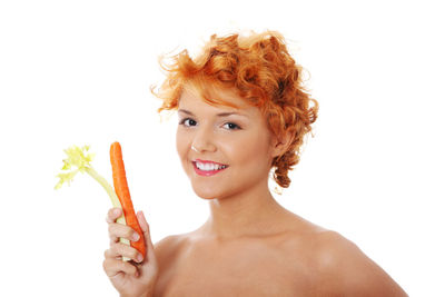 Portrait of smiling young woman against white background