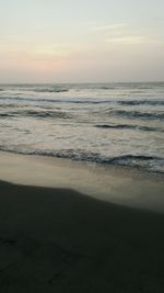 Scenic view of beach against sky during sunset