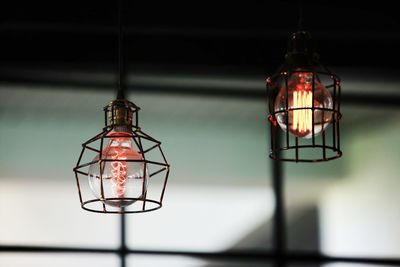 Close-up of illuminated pendant light hanging from ceiling