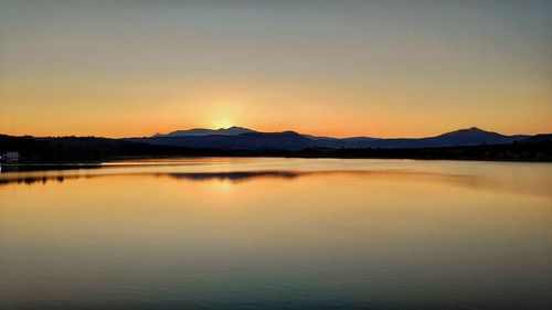 Scenic view of lake against sky during sunset