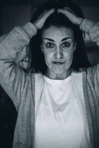 Portrait of beautiful woman standing against wall