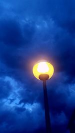 Low angle view of street light against cloudy sky