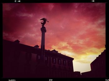 Low angle view of built structure against cloudy sky