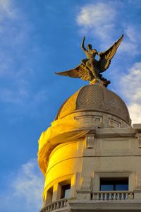 Low angle view of statue against sky