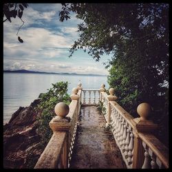 Scenic view of river against cloudy sky